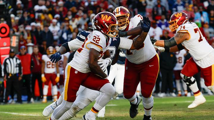 Dec 25, 2025; Landover, Maryland, USA; Washington Commanders running back Jacory Croskey-Merritt (22) carries the ball for a touchdown, defended by Dallas Cowboys defensive tackle Quinnen Williams (92) in the third quarter at Northwest Stadium. Mandatory Credit: Geoff Burke-Imagn Images Dec 25, 2025; Landover, Maryland, USA; Washington Commanders running back Jacory Croskey-Merritt (22) carries the ball for a touchdown, defended by Dallas Cowboys defensive tackle Quinnen Williams (92) in the third quarter at Northwest Stadium. Mandatory Credit: Geoff Burke-Imagn Images