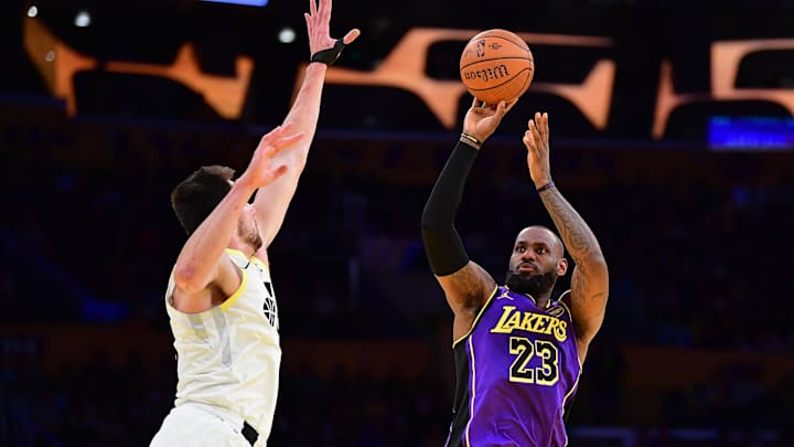 Nov 19, 2024; Los Angeles, California, USA; Los Angeles Lakers forward LeBron James (23) shoots against Utah Jazz forward Kyle Filipowski (22) during the first half at Crypto.com Arena. Mandatory Credit: Gary A. Vasquez-Imagn Images