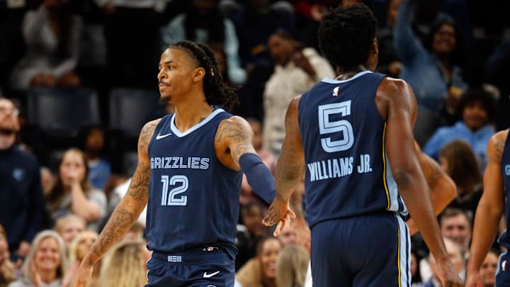 Dec 21, 2023; Memphis, Tennessee, USA; Memphis Grizzlies guard Ja Morant (12) reacts with guard Vince Williams Jr. (5) during the second half against the Indiana Pacers at FedExForum. Mandatory Credit: Petre Thomas-Imagn Images Dec 21, 2023; Memphis, Tennessee, USA; Memphis Grizzlies guard Ja Morant (12) reacts with guard Vince Williams Jr. (5) during the second half against the Indiana Pacers at FedExForum. Mandatory Credit: Petre Thomas-Imagn Images
