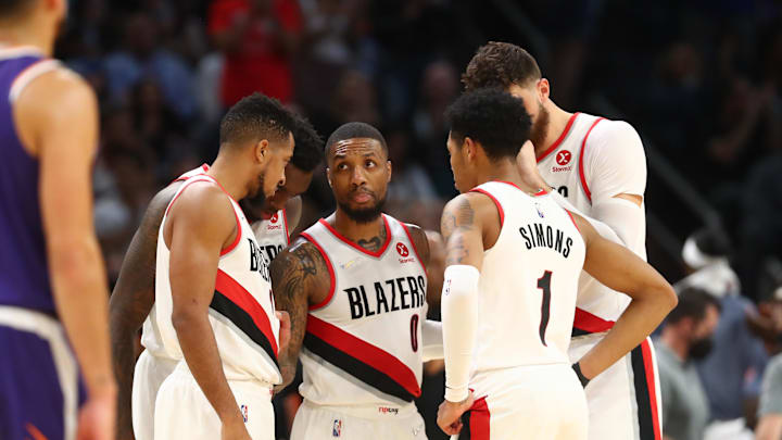 Nov 10, 2021; Phoenix, Arizona, USA; Portland Trail Blazers guard Damian Lillard (0) in the huddle with guard CJ McCollum (3) guard Anfernee Simons (1) against the Phoenix Suns at Footprint Center. Mandatory Credit: Mark J. Rebilas-Imagn Images