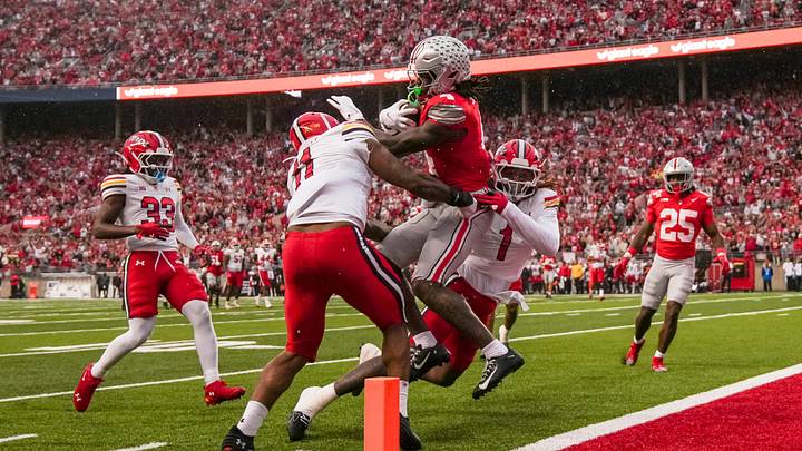 Ohio State Buckeyes wide receiver Jeremiah Smith (4) scores a touchdown past Maryland Terrapins defensive lineman Sidney Stewart (11) during the NCAA football game at Ohio Stadium in Columbus. Ohio State Buckeyes wide receiver Jeremiah Smith (4) scores a touchdown past Maryland Terrapins defensive lineman Sidney Stewart (11) during the NCAA football game at Ohio Stadium in Columbus.