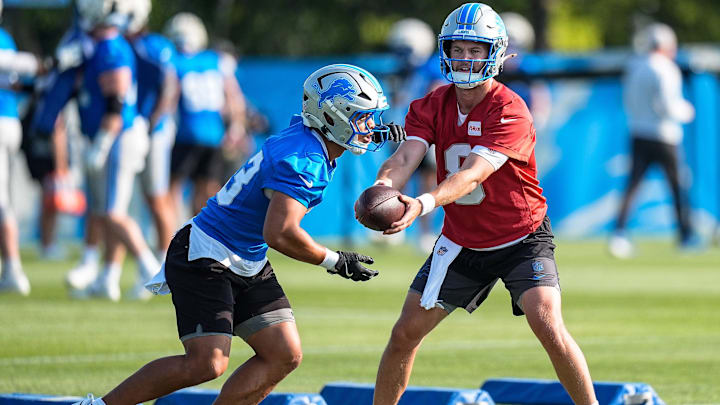 Detroit Lions quarterback Kyle Allen (8) hands the ball to running back Sione Vaki (33) at practice during training camp at Meijer Performance Center in Allen Park on Monday, July 21, 2025.