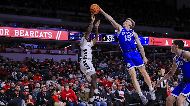 Feb 8, 2025; Cincinnati, Ohio, USA; Brigham Young Cougars forward Richie Saunders (15) blocks a shot by Cincinnati Bearcats guard Jizzle James (2) in the first half at Fifth Third Arena. Mandatory Credit: Katie Stratman-Imagn Images
