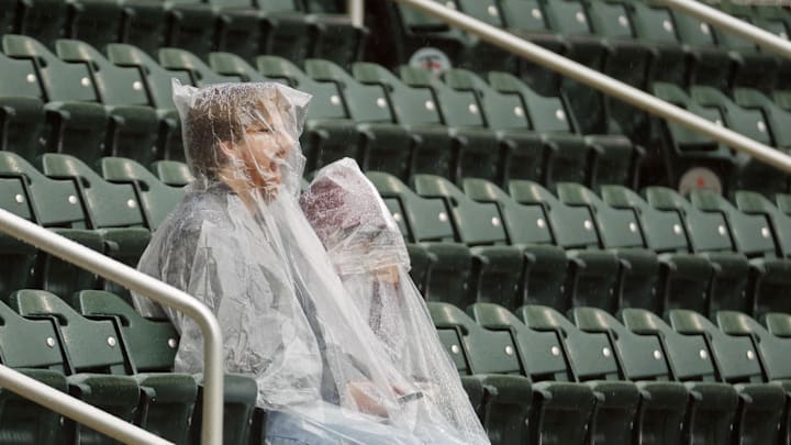 Fans sit in the rain at Target Field in Minnesota Fans sit in the rain at Target Field in Minnesota