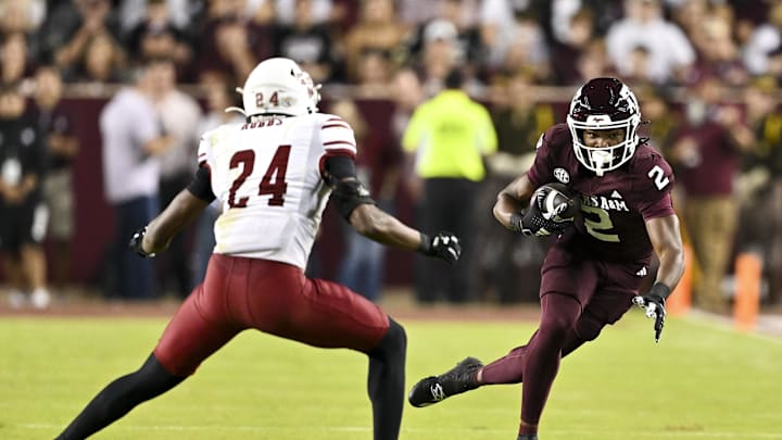 Nov 16, 2024; College Station, Texas, USA; Texas A&M Aggies wide receiver Terry Bussey (2) runs the ball as New Mexico State Aggies cornerback Dakerric Hobbs (24) defends during the first half at Kyle Field. Mandatory Credit: Maria Lysaker-Imagn Images 