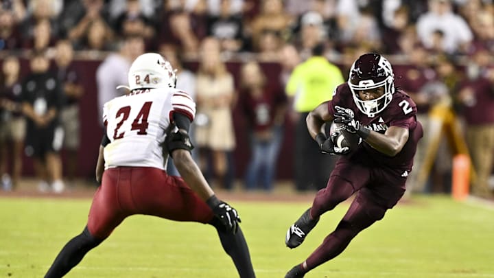 Nov 16, 2024; College Station, Texas, USA; Texas A&M Aggies wide receiver Terry Bussey (2) runs the ball as New Mexico State Aggies cornerback Dakerric Hobbs (24) defends during the first half at Kyle Field. Mandatory Credit: Maria Lysaker-Imagn Images 