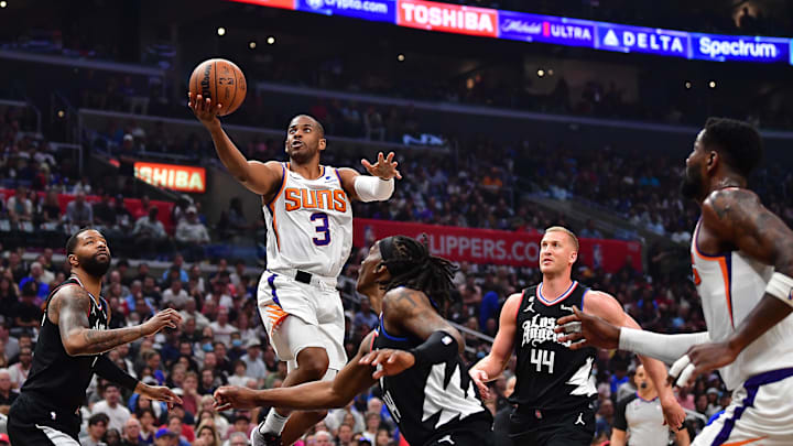 Apr 22, 2023; Los Angeles, California, USA; Phoenix Suns guard Chris Paul (3) moves to the basket against Los Angeles Clippers forward Marcus Morris Sr. (8) guard Terance Mann (14) and center Mason Plumlee (44)  during the first half in game four of the 2023 NBA playoffs at Crypto.com Arena. Mandatory Credit: Gary A. Vasquez-Imagn Images