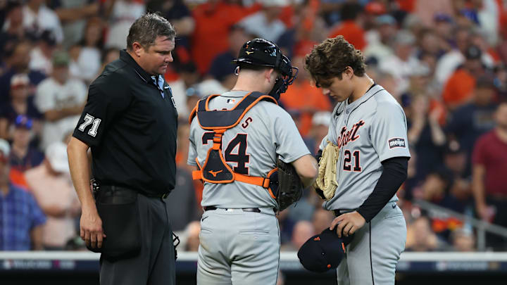 Home plate umpire Jordan Baker inspects the equipment  of Detroit Tigers pitcher Jackson Jobe (21) as catcher Jake Rogers (34) looks on during the seventh inning of game two of the Wildcard round for the 2024 MLB Playoffs against the Houston Astros at Minute Maid Park on Oct 2.