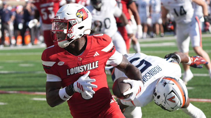 Louisville’s Chris Bell makes Virginia’s Kam Robinson miss and scores a touchdown at L&N Stadium Saturday.
Ocr. 4, 2025