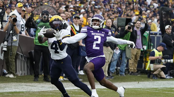 Nov 15, 2025; Chicago, Illinois, USA; Michigan Wolverines wide receiver Andrew Marsh (4) makes a catch as Northwestern Wildcats cornerback Fred Davis II (2) defends him during the first half at Wrigley Field. Mandatory Credit: David Banks-Imagn Images