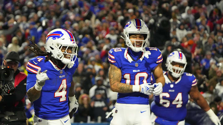 Dec 17, 2023; Orchard Park, New York, USA; Buffalo Bills running back James Cook (4) celebrates a touchdown with Buffalo Bills wide receiver Khalil Shakir (10) in the first half against the Dallas Cowboys