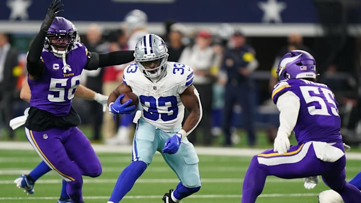 Dec 14, 2025; Arlington, Texas, USA; Dallas Cowboys running back Javonte Williams (33) runs against Minnesota Vikings linebacker Jonathan Greenard (58) and linebacker Eric Wilson (55) during the second half at AT&T Stadium. Mandatory Credit: Raymond Carlin III-Imagn Images