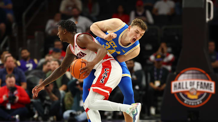 Dec 14, 2024; Phoenix, Arizona, USA; UCLA Bruins forward Tyler Bilodeau (34) reacts as Arizona Wildcats guard Jaden Bradley (0) collides with him in the second half at Footprint Center. Mandatory Credit: Mark J. Rebilas-Imagn Images