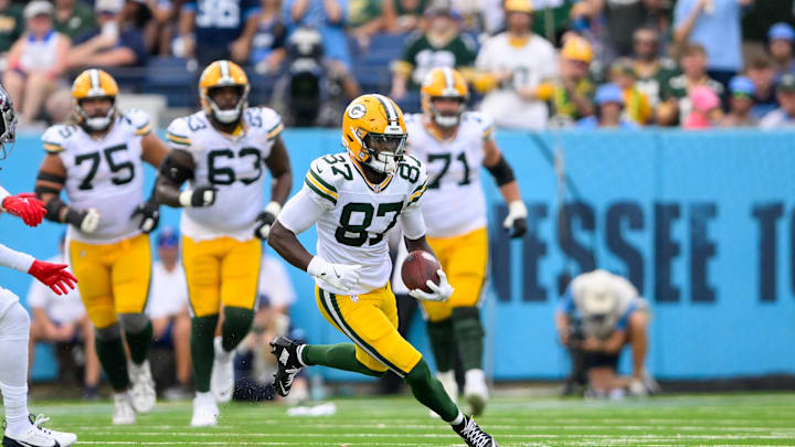 Sep 22, 2024; Nashville, Tennessee, USA;  Green Bay Packers wide receiver Romeo Doubs (87) makes a catch and runs the ball against the Tennessee Titans during the first half at Nissan Stadium. Mandatory Credit: Steve Roberts-Imagn Images