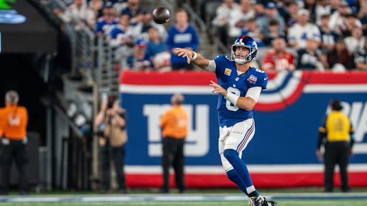Sep 26, 2024; East Rutherford, NJ, US; New York Giants quarterback Daniel Jones (8) passes the ball while scrambling away from Dallas Cowboys defensive end Carl Lawson (55) at MetLife Stadium.  