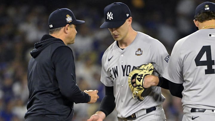 Oct 26, 2024; Los Angeles, California, USA; New York Yankees manager Aaron Boone (17) relieves pitcher Jake Cousins (61) in the fifth inning against the Los Angeles Dodgers during game two of the 2024 MLB World Series at Dodger Stadium. Mandatory Credit: Jayne Kamin-Oncea-Imagn Images