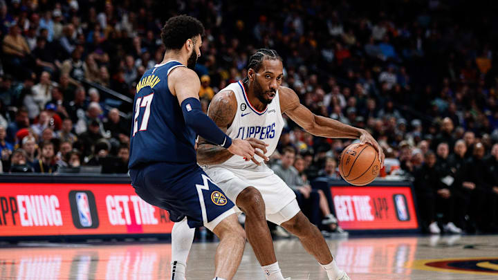 Jan 5, 2023; Denver, Colorado, USA; Los Angeles Clippers forward Kawhi Leonard (2) controls the ball as Denver Nuggets guard Jamal Murray (27) guards in the first quarter at Ball Arena. 