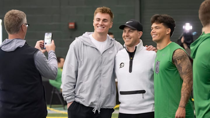 Denver Broncos quarterback Bo Nix, a former Oregon quarterback, left, and Oregon quarterback Dillon Gabriel, right, take a picture with Oregon offensive coordinator and quarterbacks coach Will Stein during the Oregon football’s Pro Day Tuesday, March 18, 2025, at the Moshofsky Center in Eugene, Ore.