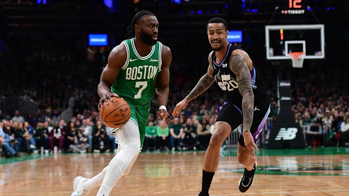 Mar 10, 2025; Boston, Massachusetts, USA;  Boston Celtics guard Jaylen Brown (7) controls the ball while Utah Jazz forward John Collins (20) defends during the first half at TD Garden. Mandatory Credit: Bob DeChiara-Imagn Images
