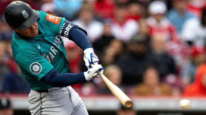 Seattle Mariners right fielder Dylan Moore hits an RBI base hit in the second inning of the MLB game between Cincinnati Reds and Seattle Mariners at Great American Ball Park in Cincinnati on Tuesday, April 15, 2025. Seattle Mariners right fielder Dylan Moore hits an RBI base hit in the second inning of the MLB game between Cincinnati Reds and Seattle Mariners at Great American Ball Park in Cincinnati on Tuesday, April 15, 2025.