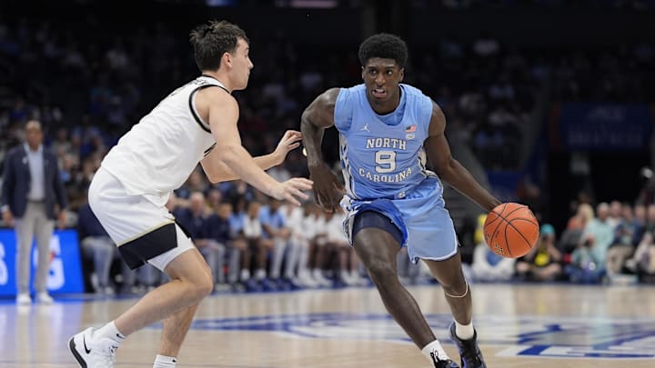 Mar 13, 2025; Charlotte, NC, USA; North Carolina Tar Heels guard Drake Powell (9) goes to the basket against Wake Forest Demon Deacons guard Parker Friedrichsen (7) during the first half at Spectrum Center. Mandatory Credit: Jim Dedmon-Imagn Images