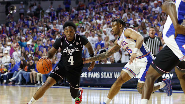 Mar 1, 2025; Gainesville, Florida, USA; Texas A&M Aggies guard Wade Taylor IV (4) dribbles the ball around Florida Gators guard Alijah Martin (15) during the first half at Exactech Arena at the Stephen C. O'Connell Center. Mandatory Credit: Morgan Tencza-Imagn Images