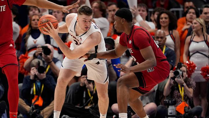 Mar 12, 2026; Charlotte, NC, USA; Virginia Cavaliers forward Thijs De Ridder (28) handles the ball against NC State Wolfpack guard Paul McNeil (2) during the second half at Spectrum Center. Mandatory Credit: Jim Dedmon-Imagn Images Mar 12, 2026; Charlotte, NC, USA; Virginia Cavaliers forward Thijs De Ridder (28) handles the ball against NC State Wolfpack guard Paul McNeil (2) during the second half at Spectrum Center. Mandatory Credit: Jim Dedmon-Imagn Images