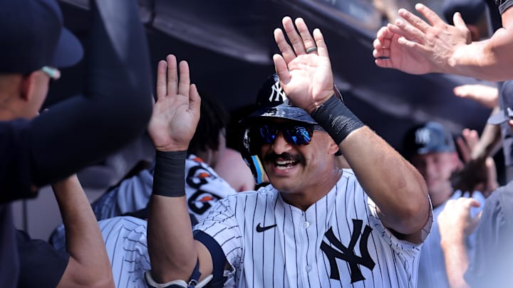 Aug 3, 2024; Bronx, New York, USA; New York Yankees center fielder Trent Grisham (12) celebrates his two run home run against the Toronto Blue Jays with teammates in the dugout during the second inning at Yankee Stadium. Mandatory Credit: Brad Penner-Imagn Images