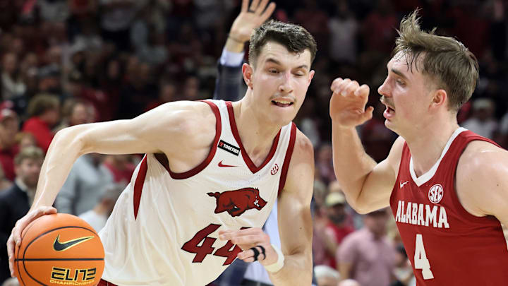Feb 8, 2025; Fayetteville, Arkansas, USA; Arkansas Razorbacks forward Zvonimir Ivisic (44) drives against Alabama Crimson Tide forward Grant Nelson (4) during the first half at Bud Walton Arena. Mandatory Credit: Nelson Chenault-Imagn Images
