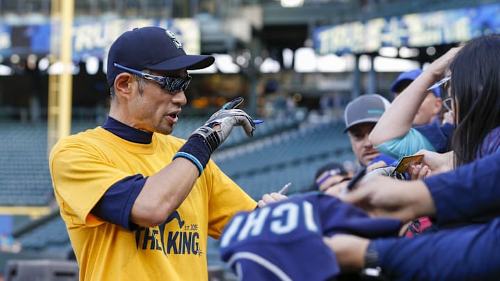 Seattle Mariners former outfielder Ichiro Suzuki (51) signs autographs for fans during batting practice against the Oakland Athletics while wearing a t-shirt honoring starting pitcher Felix Hernandez (not pictured) at T-Mobile Park in 2019. Seattle Mariners former outfielder Ichiro Suzuki (51) signs autographs for fans during batting practice against the Oakland Athletics while wearing a t-shirt honoring starting pitcher Felix Hernandez (not pictured) at T-Mobile Park in 2019.