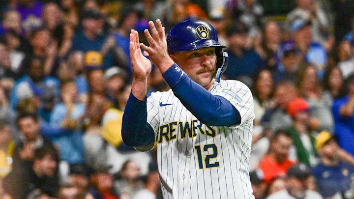Sep 28, 2024; Milwaukee, Wisconsin, USA; Milwaukee Brewers first baseman Rhys Hoskins (12) reacts after scoring a run in the fourth inning against the New York Mets at American Family Field. Mandatory Credit: Benny Sieu-Imagn Images