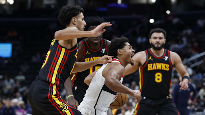 Oct 30, 2024; Washington, District of Columbia, USA; Washington Wizards guard Jordan Poole (13) drives to the basket as Atlanta Hawks forward Zaccharie Risacher (10), Hawks center Clint Capela (15), and Hawks forward David Roddy (8) defend in the second half at Capital One Arena. Mandatory Credit: Geoff Burke-Imagn Images Oct 30, 2024; Washington, District of Columbia, USA; Washington Wizards guard Jordan Poole (13) drives to the basket as Atlanta Hawks forward Zaccharie Risacher (10), Hawks center Clint Capela (15), and Hawks forward David Roddy (8) defend in the second half at Capital One Arena. Mandatory Credit: Geoff Burke-Imagn Images