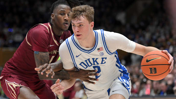 Mar 1, 2025; Durham, North Carolina, USA;  Duke Blue Devils forward Cooper Flagg (2) brings the ball around Florida State Seminoles guard Jamir Watkins (1) during the second half at Cameron Indoor Stadium.  Blue Devils won 100-65. Mandatory Credit: Zachary Taft-Imagn Images