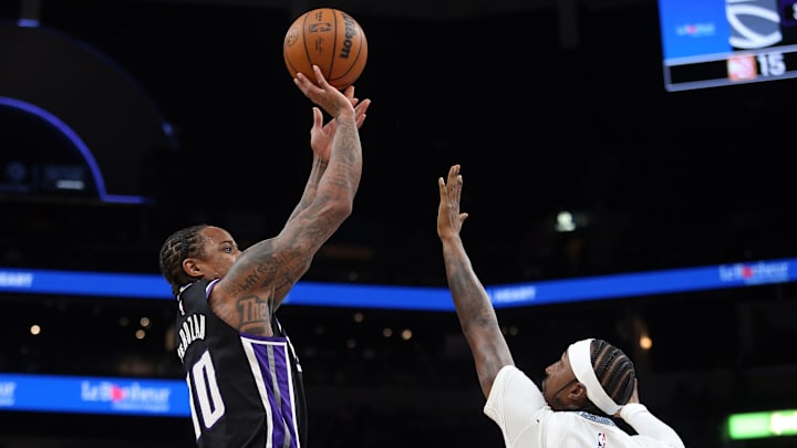 Nov 20, 2025; Memphis, Tennessee, USA; Sacramento Kings guard DeMar DeRozan (10) shoots as Memphis Grizzlies forward Kentavious Caldwell-Pope (3) defends during the first quarter at FedExForum. Mandatory Credit: Petre Thomas-Imagn Images