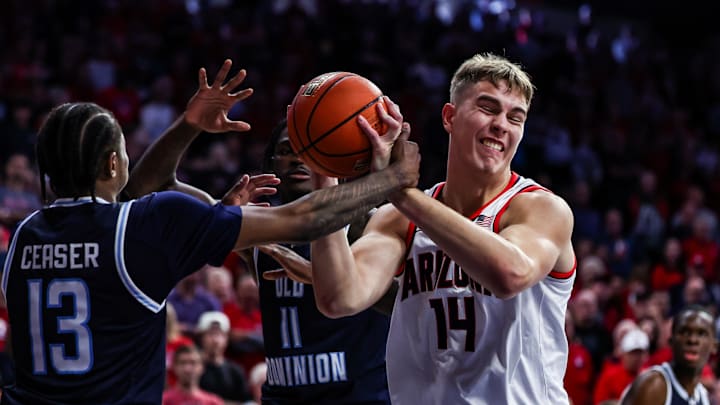 Nov 9, 2024; Tucson, Arizona, USA; Old Dominion Monarchs guard Devin Ceaser (13) fouls Arizona Wildcats center Motiejus Krivas (14) during the second half at McKale Center. Mandatory Credit: Aryanna Frank-Imagn Images