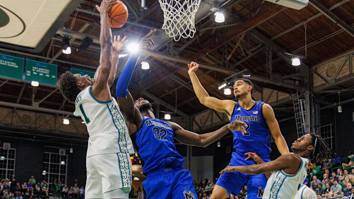 Jan 30, 2025; New Orleans, Louisiana, USA;  Tulane Green Wave forward Kaleb Banks (1) secures a rebound against Memphis Tigers center Moussa Cisse (32) during the first half at Avron B. Fogelman Arena in Devlin Fieldhouse.