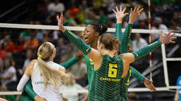 Oregon's Noemie Glover, center, joins her teammates in celebration after defeating Oregon State in straight sets on Sunday, Sept. 22, 2024.