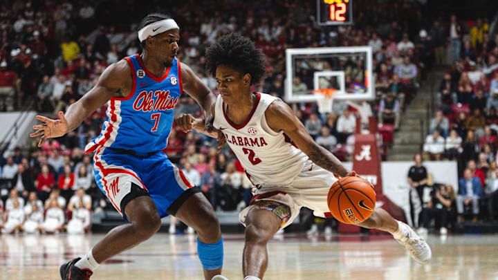 Jan 14, 2025; Tuscaloosa, Alabama, USA; Alabama Crimson Tide guard Aden Holloway (2) works against Mississippi Rebels guard Davon Barnes (7) during the second half at Coleman Coliseum. Mandatory Credit: Will McLelland-Imagn Images
