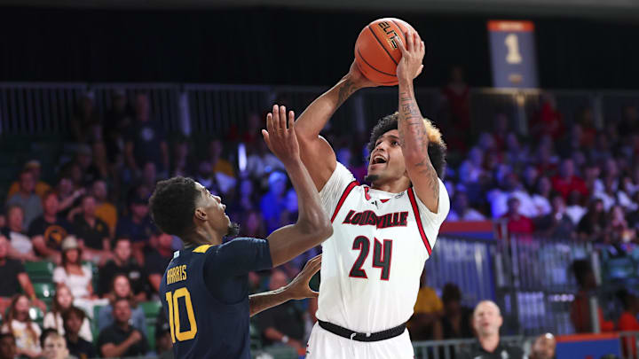 Nov 28, 2024; Paradise Island, Bahamas, BHS; Louisville Cardinals guard Chucky Hepburn (24) shoots as West Virginia Mountaineers guard Sencire Harris (10) defends during the first half at Imperial Arena at the Atlantis resort. Mandatory Credit: Kevin Jairaj-Imagn Images Nov 28, 2024; Paradise Island, Bahamas, BHS; Louisville Cardinals guard Chucky Hepburn (24) shoots as West Virginia Mountaineers guard Sencire Harris (10) defends during the first half at Imperial Arena at the Atlantis resort. Mandatory Credit: Kevin Jairaj-Imagn Images