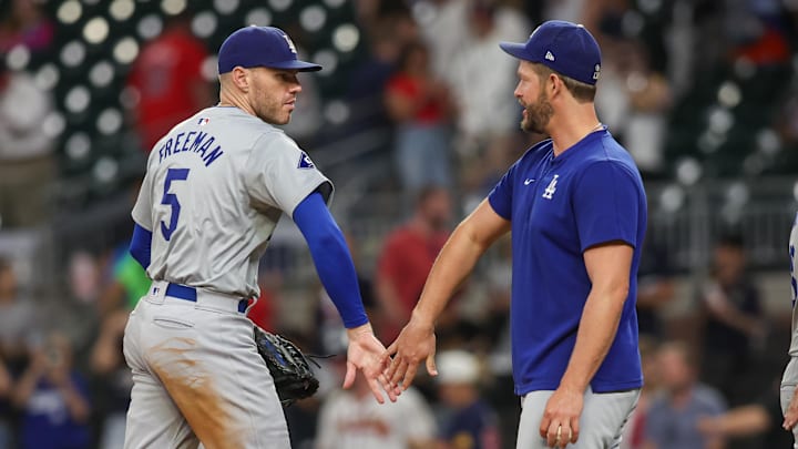 Los Angeles Dodgers first baseman Freddie Freeman (5) and starting pitcher Clayton Kershaw (22) celebrate after a victory over the Atlanta Braves.