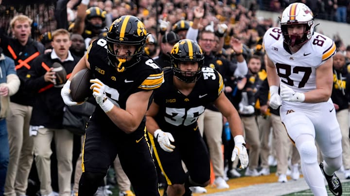 Iowa Hawkeyes defensive back Zach Lutmer (6) returns an interception for a touchdown against the Minnesota Golden Gophers Oct. 25, 2025 at Kinnick Stadium in Iowa City, Iowa. Iowa Hawkeyes defensive back Zach Lutmer (6) returns an interception for a touchdown against the Minnesota Golden Gophers Oct. 25, 2025 at Kinnick Stadium in Iowa City, Iowa.