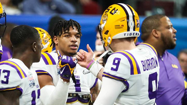 Dec 28, 2019; Atlanta, Georgia, USA; LSU Tigers wide receiver Ja'Marr Chase (1) greets quarterback Joe Burrow (9) before the 2019 Peach Bowl college football playoff semifinal game between the LSU Tigers and the Oklahoma Sooners at Mercedes-Benz Stadium. Mandatory Credit: Jason Getz-USA TODAY Sports Dec 28, 2019; Atlanta, Georgia, USA; LSU Tigers wide receiver Ja'Marr Chase (1) greets quarterback Joe Burrow (9) before the 2019 Peach Bowl college football playoff semifinal game between the LSU Tigers and the Oklahoma Sooners at Mercedes-Benz Stadium. Mandatory Credit: Jason Getz-USA TODAY Sports