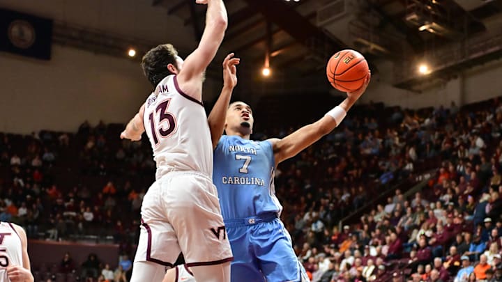 Mar 4, 2025; Blacksburg, Virginia, USA; North Carolina Tar Heels guard Seth Trimble (7) goes up for a layup as Virginia Tech Hokies forward Ben Burnham (13) defends during the second half at Cassell Coliseum. Mandatory Credit: Brian Bishop-Imagn Images Mar 4, 2025; Blacksburg, Virginia, USA; North Carolina Tar Heels guard Seth Trimble (7) goes up for a layup as Virginia Tech Hokies forward Ben Burnham (13) defends during the second half at Cassell Coliseum. Mandatory Credit: Brian Bishop-Imagn Images
