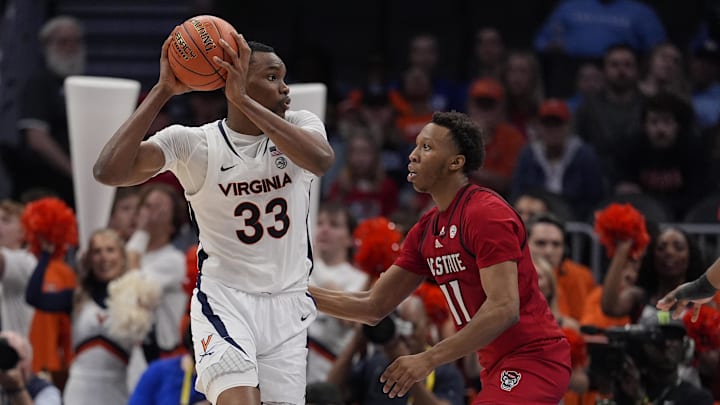 Virginia Cavaliers center Ugonna Onyenso and NC State Wolfpack guard Quadir Copeland