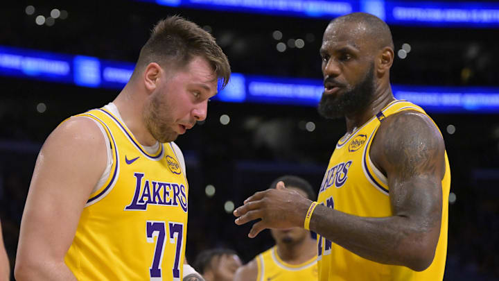 Feb 10, 2025; Los Angeles, California, USA; Los Angeles Lakers forward LeBron James (23) checks on guard Luka Doncic (77) after he was hit in the face against the Utah Jazz at Crypto.com Arena. Mandatory Credit: Jayne Kamin-Oncea-Imagn Images