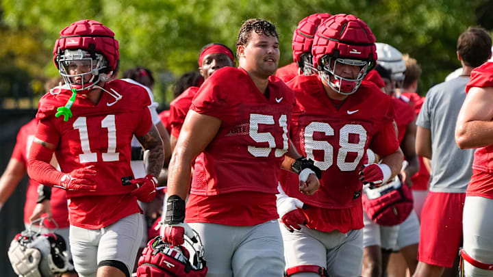 Aug 1, 2024; Columbus, OH, USA; Ohio State Buckeyes wide receiver Brandon Inniss (11), offensive lineman Luke Montgomery (51) and offensive lineman George Fitzpatrick (68) run during football camp at the Woody Hayes Athletic Complex.