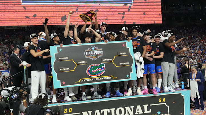 Apr 7, 2025; San Antonio, TX, USA;  Florida Gators players celebrate with the trophy after defeating the Houston Cougars in the national championship game of the Final Four of the 2025 NCAA Tournament at the Alamodome. Mandatory Credit: Robert Deutsch-Imagn Images
