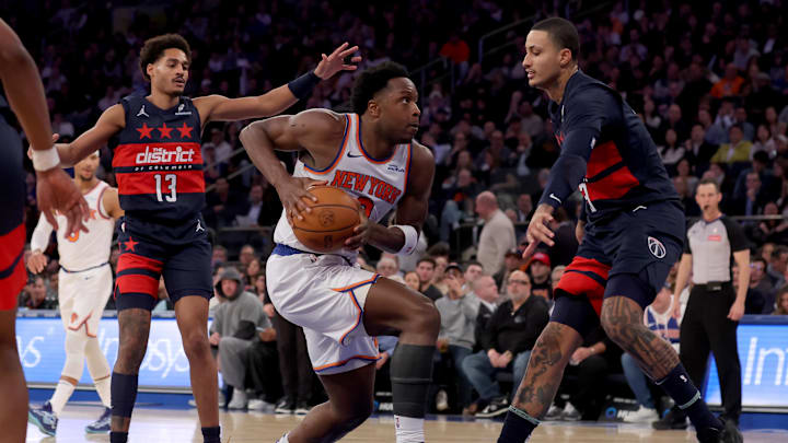 Nov 18, 2024; New York, New York, USA; New York Knicks forward OG Anunoby (8) drives to the basket against Washington Wizards guard Jordan Poole (13) and forward Kyle Kuzma (33) during the third quarter at Madison Square Garden. Mandatory Credit: Brad Penner-Imagn Images Nov 18, 2024; New York, New York, USA; New York Knicks forward OG Anunoby (8) drives to the basket against Washington Wizards guard Jordan Poole (13) and forward Kyle Kuzma (33) during the third quarter at Madison Square Garden. Mandatory Credit: Brad Penner-Imagn Images