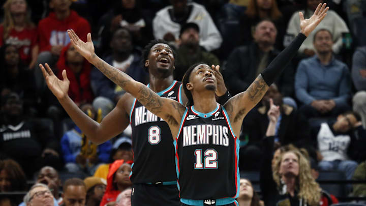 Nov 9, 2025; Memphis, Tennessee, USA; Memphis Grizzlies forward/center Jaren Jackson Jr. (8) and guard Ja Morant (12) react during the third quarter against the Oklahoma City Thunder at FedExForum. Mandatory Credit: Petre Thomas-Imagn Images