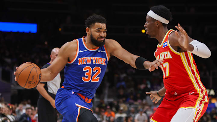 Dec 27, 2025; Atlanta, Georgia, USA; New York Knicks center Karl-Anthony Towns (32) is defended by Atlanta Hawks forward Onyeka Okongwu (17) in the first quarter at State Farm Arena. Mandatory Credit: Brett Davis-Imagn Images
